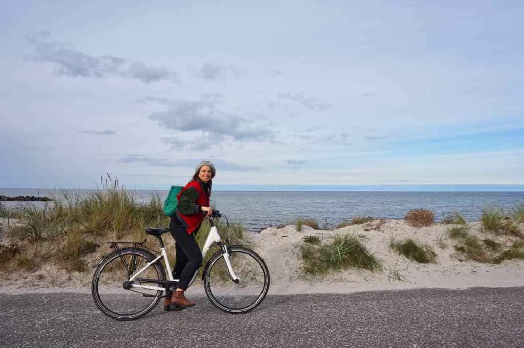 Marie fährt mit dem Fahrrad entlang der Küste in Schönberg an der Ostsee