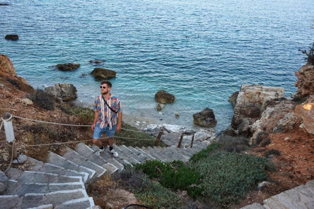 Chris geht die Treppe hoch vom Secret Beach in Piso Livadi auf Paros.